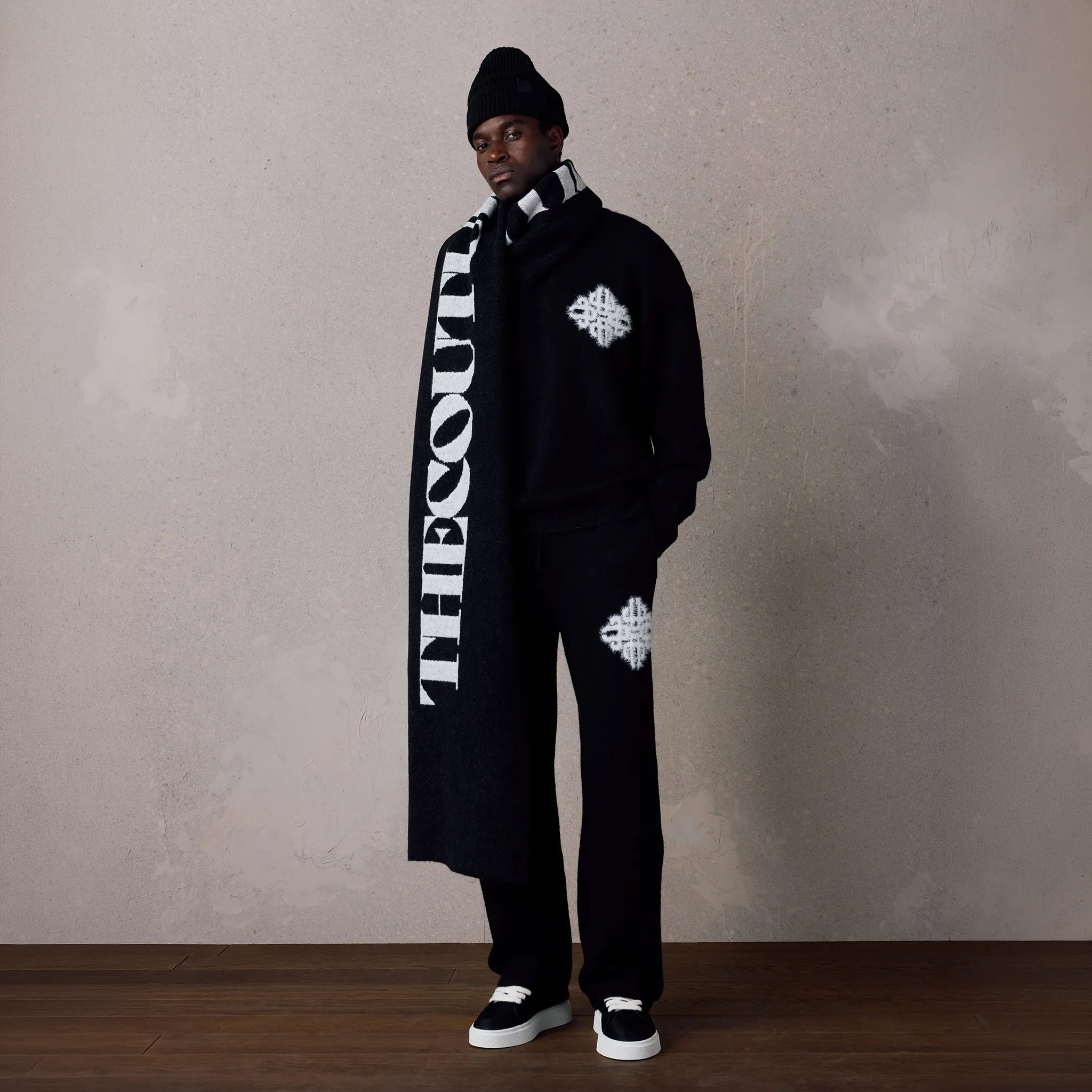 Front View of The Couture Club Emblem Fluffy Knit Black Sweatpants